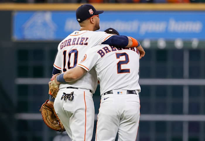 Yuli Gurriel puts his arm around Houston Astros teammate Alex Bregman.